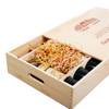 A wooden gift box in natural wood finish, holding six wine bottles with decorative packing straw inside.