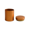 A small metallic orange cylinder canister with a matching lid, suitable for storage or display.