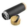 A black vacuum drink bottle with a bamboo lid and silver detailing. It features a smooth, matte finish and a logo.
