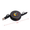 A retractable portable charging cable in black, featuring dual connectors and a logo on the circular casing.