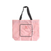 A pink foldable tote bag with black handles and a front zippered pocket. It features a logo on the front.