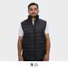 A man wears a black puffer vest with a high collar and two front zip pockets. The vest features a logo.