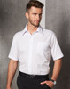 A short-sleeve white button-up business shirt with a pocket, worn by a male model against a grey backdrop.