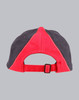 A tri-colour cap featuring red and navy panels, with an adjustable strap at the back and a logo.