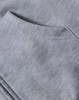 A light grey men's full-zip fleecy hoodie with a front pocket and soft, textured fabric. Features branding.