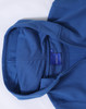 A blue full-zip fleecy hoodie with a spacious hood and a label inside.