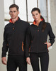 A black softshell jacket with orange highlights, featuring a zip front and pockets, displayed on a male and female model.