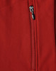 A close-up of a red softshell vest featuring a zippered pocket and a logo.