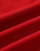 A red softshell fabric showcasing smooth texture and subtle folds, suitable for jackets. Features a logo.