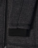 A dark heather grey fleece jacket with a black ribbed cuff and zipper detail. It also features a logo.