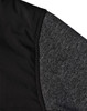 A close-up of a men's jacket featuring a quilted black body and grey heather sleeves, with a logo visible.