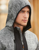 A grey work hoodie featuring a hood and a zippered front, displayed on a model with a neutral background.