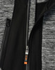 A grey and black jacket featuring a zippered front and a logo on the zipper pull.