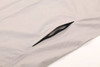 A light grey men's waterproof performance jacket featuring a side pocket, designed for rain protection.
