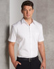 A white short-sleeved button-up shirt featuring a pocket, worn by a man against a textured background.
