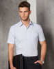 A men's short-sleeve button-up shirt in light blue, featuring a chest pocket and a logo. Styled with black trousers.