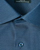 A close-up of a blue pin dot stretch button-up shirt featuring a patterned fabric and a branded tag.