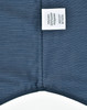A button-up shirt featuring a pin dot pattern in navy blue, with a care label attached.