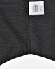 A black pin dot stretch short-sleeve shirt with a care label and a subtle pattern. Features a logo on the label.
