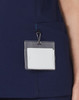 A navy scrub top with a pocket and a badge holder attached.
