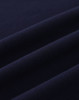 A close-up of navy cotton fabric with visible texture and stretch features, suitable for polo shirts.