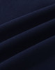 A close-up of navy cotton fabric with visible stretch and texture, ideal for polo shirts.
