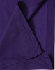 A purple polo shirt featuring a textured fabric and neat stitching, with a logo on the label.