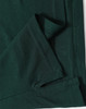 A dark green men's polo shirt featuring a folded hem and stitching details, including a logo.