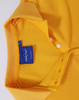 A yellow polo shirt featuring a collar, buttons, and a branded tag inside the neck.