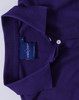 A purple ladies' polo shirt featuring a classic collar and a logo tag near the neckline.