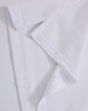 A close-up of a white polo shirt fabric, showcasing the collar and stitching details. Contains a logo.