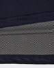 A close-up of a navy and charcoal polo shirt, featuring a textured fabric and a logo.