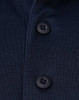 A navy blue polo shirt featuring black buttons and a clean, textured fabric. It has a logo on the garment.