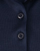 Close-up of a navy blue polo shirt featuring a button placket and a logo.