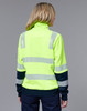 A high-visibility yellow jumper with reflective stripes, featuring a dark blue sleeve section and a high collar.