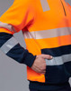 An orange and navy work jumper featuring reflective stripes and a front pocket. Includes a partial zip at the collar.
