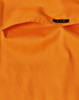 An orange work shirt featuring a pocket and a tag with a logo.