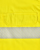 A bright yellow safety shirt featuring segmented reflective tape and a pocket. It has a logo on the fabric.