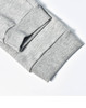 A close-up of grey poly/cotton terry sweat pant cuffs featuring ribbed texture and stitching details.