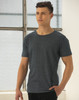 A model wearing a blue heather short-sleeve t-shirt with a relaxed fit, featuring a visible logo.
