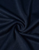 A close-up of navy blue textured fabric, displaying a smooth, lightweight weave. The fabric has a logo present.