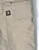 A pair of beige work shorts featuring a zip pocket and a logo patch. The fabric has a rip-stop texture.