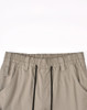 Pair of unisex cotton stretch drill work pants in a beige colour with an elasticised waistband and drawstring detail.