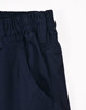 Unisex navy cotton stretch drill cuffed work pants with an elastic waistband and side pockets. Features a logo.