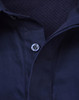 A navy blue long sleeve work shirt with a closed front and mesh interior. It features a button at the collar and has a branded logo.