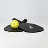 A black pickleball set featuring two paddles and a yellow ball, with a logo on the paddles.