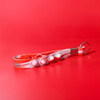 A red and white Popper Stress Reliever Key Chain with multiple popping buttons and a key ring attachment.