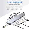 A silver 7 in 1 USB hub with multiple ports, including USB 3.0 and Type-C, against a white background.