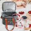 A grey 10L cooler bag with an orange handle, displaying an empty interior beside fruits and snacks on a picnic blanket.