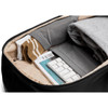 A sleek black backpack interior with neatly folded clothing, socks, and a keyboard in organised compartments.